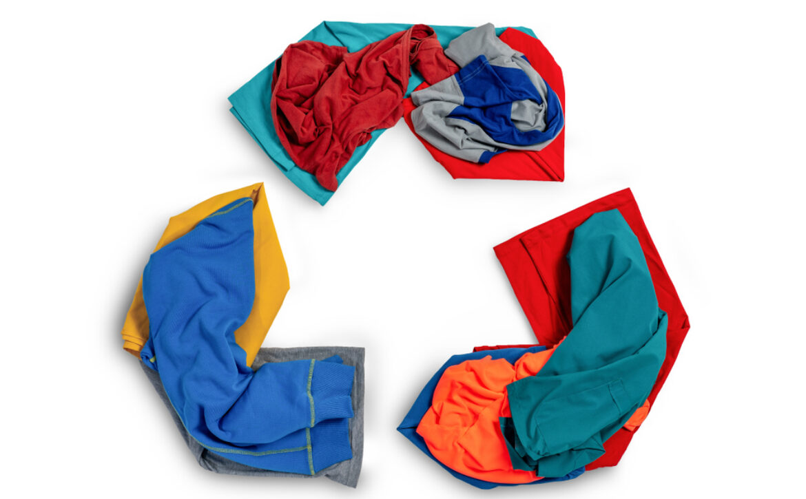 Clothes organized in the shape of a recycling logo.