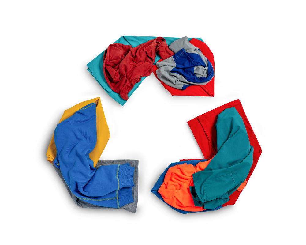 Clothes organized in the shape of a recycling logo.