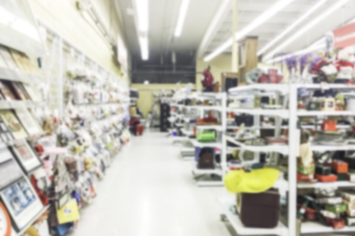 Out-of-focus isles and wall displays in a thrift store.
